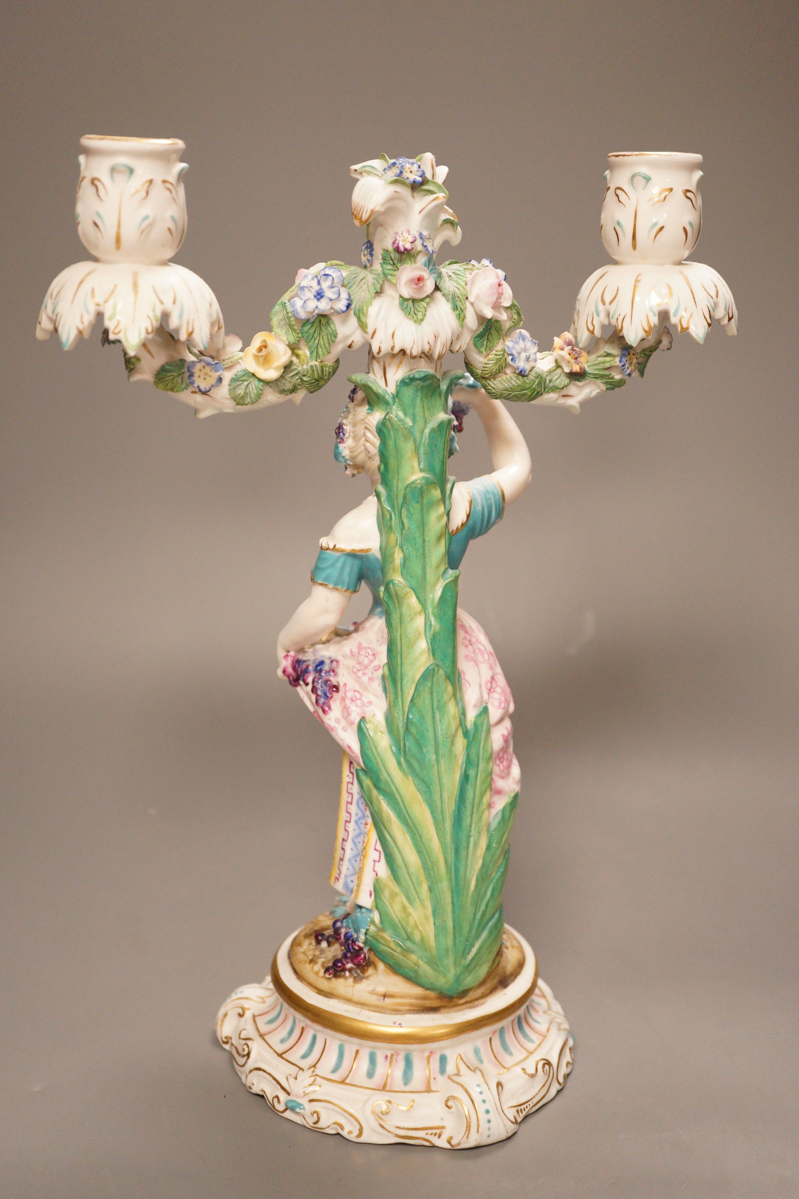 A 19th century English porcelain figural twin branch candelabrum, probably Minton, c.1835, 34cm